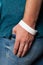 White party bracelet on hand. Music festival wristband, concert event mockup