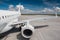 White passenger airliner on the airport apron. View of the wing and rear airplane