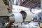 White passenger airliner in the aviation hangar. Jetliner under maintenance