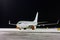 White passenger airplane on the night airport apron at winter