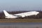 White passenger commercial plane takes off from runway side view