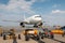 White passenger jet plane and aircraft towbars at the airport apron