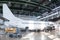 White passenger jetliner in the aviation hangar. Jet plane under maintenance