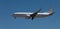 White passenger plane against blue sky