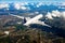 White passenger plane in flight. Aircraft flies above the big city.