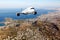 White passenger plane in flight. Aircraft flies above the big city. Front view