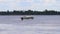 White passenger ship sails near buoy on river at summer day