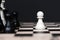 White pawn chess in front of row of black chess