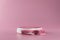 White pedestal or podium display with pink fabric platform on valentines concept background. Blank cosmetic shelf stand for