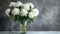 White peonies bouquet in glass vase on marble table