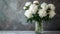 White peonies in a glass vase on a textured background