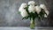 White peonies in a glass vase on a textured background