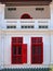 White Peranakan shophouse with red windows