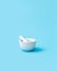 White pharmacy mortar and pestle on the blue background. Visual concept