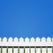 White picket fence and blue sky