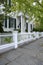 White picket fence by a typical federal style house