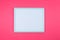White picture frame on pink background. neon