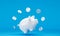 White piggy bank with floating dollar silver coins on blue background