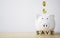 White piggy bank saving with golden coins falling for deposit and money saving investment concept