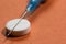 White pill and blue syringe on an orange background, soft focus