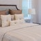 White pillows on white bed with luxury lamp
