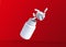White pills fly out of a flying bottle on red background with copy space