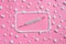 White pills and mercury thermometer pink background