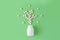 White pills in shape of tree on green background. Natural medical pharmacy concept. Probiotics benefits.