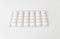 White pills tablets in package on a white background. Capsule pills in plastic pack for pharmacy and medicine