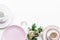 White and pink plates and flowers for table setting frame on white background top view mockup
