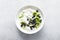 White plain greek yogurt with fresh blueberries and kiwi fruit, top view