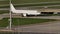 White plane doing taxi on Munich Airport, blue sky