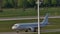 White plane doing taxi on Munich Airport, green grass