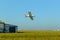 White plane fumigating rice fields with blue sky