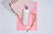 White plastic bottle, container for shampoo and cosmetics with place for inscription on pink background.