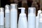 White plastic bottles with the batcher for cosmetic production