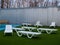 White plastic chaise lounges stand near the pool with hot thermal water