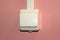 White plastic electrical switch on a pink wall