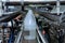 White plastic gallons or bottle on the production line of the conveyor at filling machine in the factory. selective focus.