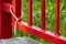 White plastic handcuffs and red garden iron fence