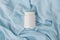 White plastic jar with vitamins and bioactive additives. Useful pills for youthful skin on a beautiful blue background with copy