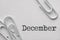 White plastic paper clips with December word