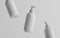 White Plastic Pump Bottle Mock-Up - Liquid Soap, Sanitizer, Shampoo Dispenser - Three Floating Bottles. 3D Illustration