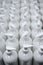 White plastic soap bottles in rows assembly line