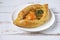 White plate with Adjarian Khachapuri â€“ Georgian cheese bread on Provence style background. Baked open pie with cheese and egg