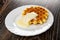 White plate with biscuit waffle poured condensed milk