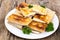 White plate with envelopes of thin Armenian bread lavash fried