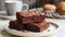 A white plate filled with brownies resting on top of a wooden table in a simple yet inviting display for dessert lovers.