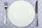 White plate, fork and knife