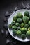 A white plate with frozen Brussels cabbage heads covered with melting ice and hoarfrost. frozen green vegetables product